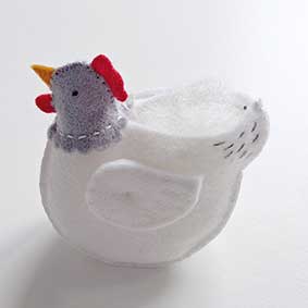 image of a small white felt hen all sewn up except for the back, where the filling is inserted.