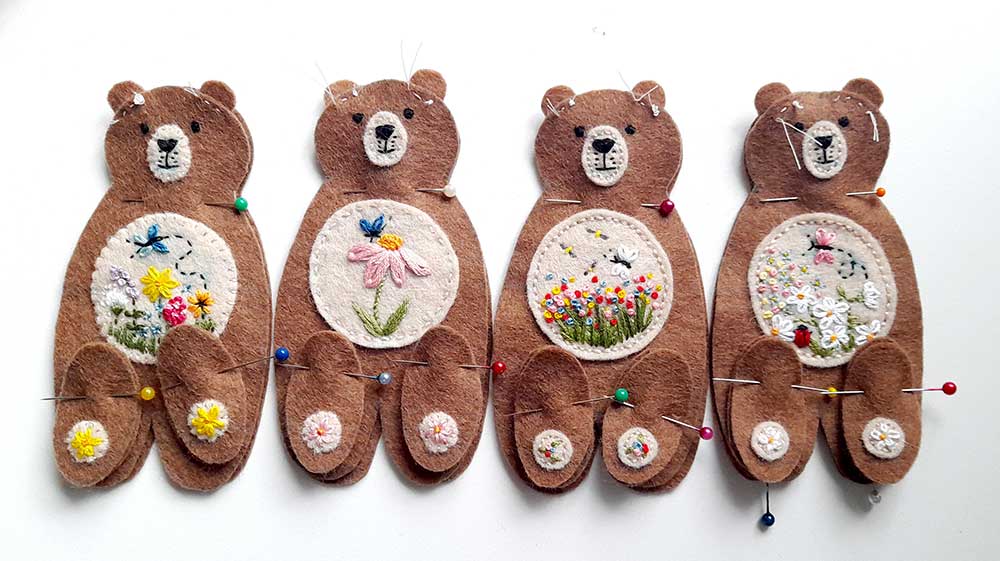 Four little brown bears in a row